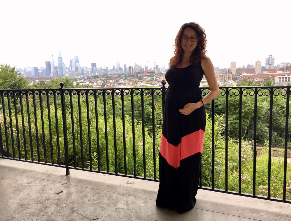 Happy Pregnant Woman in Chevron Printed Maternity Maxi Dress