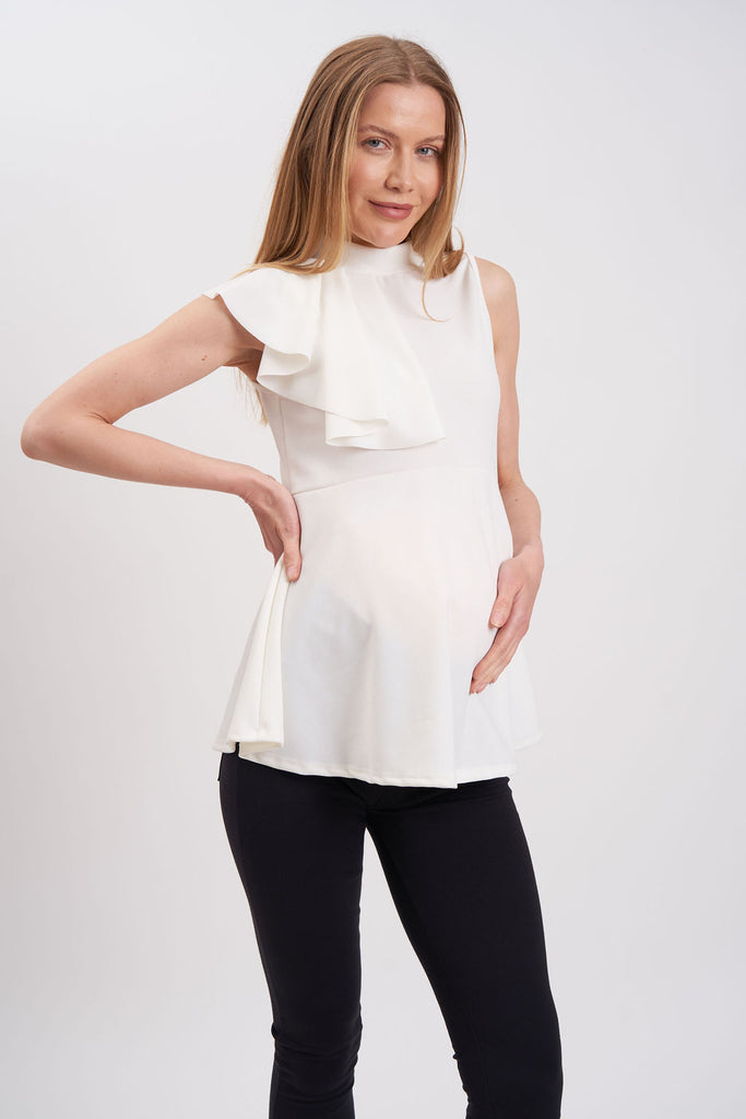 Sleeveless maternity blouse with ruffle on one shoulder.
