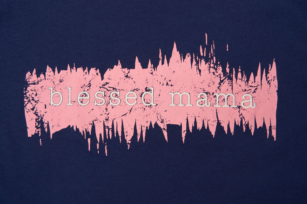 Graphic women’s t-shirt with printed “Blessed Mama” lettering with pink coloring surrounding the text